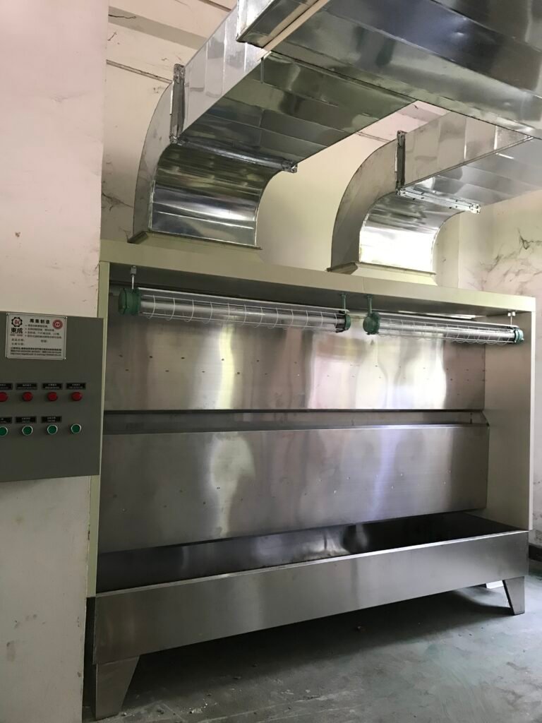 Dongcheng water curtain spray booth with overhead lighting, side controls and exhaust ducts